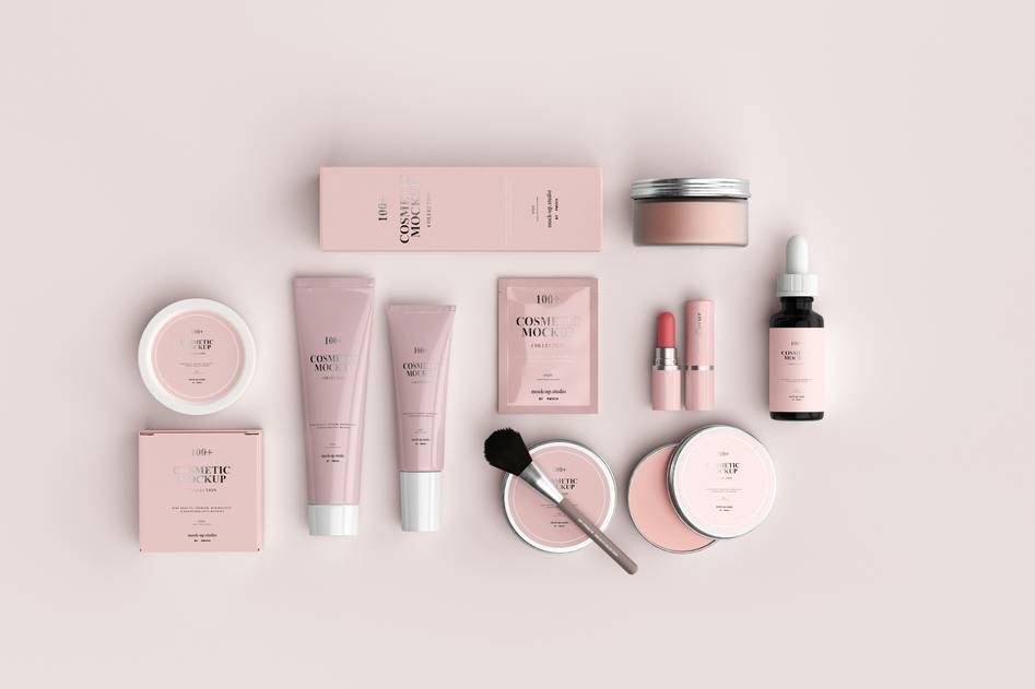 Collection of hair spray products on a vanity with beauty tools