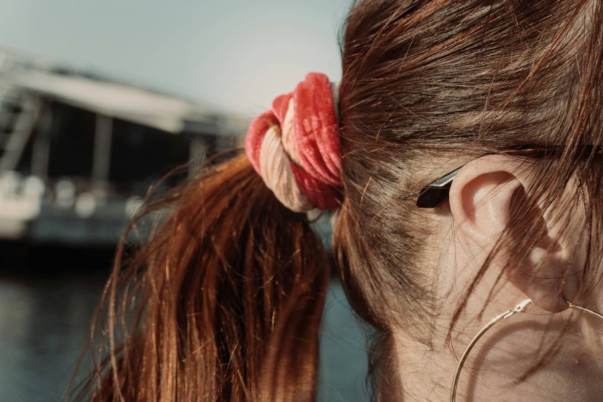 Side-by-side comparison: stiff vs. flexible hold hair spray on ponytails showing flaking vs. natural movement